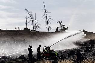 Michael Reichel/dpa | Feuerwehrleute bekämpfen versteckte Glutnester beim Waldbrand auf der Saalfelder Höhe.