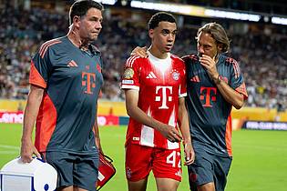Sven Hoppe/dpa | Jamal Musiala musste nur 25 Minuten nach seiner Einwechselung angeschlagen vom Platz, begleitet von Teamarzt (r) und Physiotherapeut. 